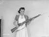 July, 1941 - Woman poses with finished rifle and bayonet.  Photo courtesy Library and Archives Canada.